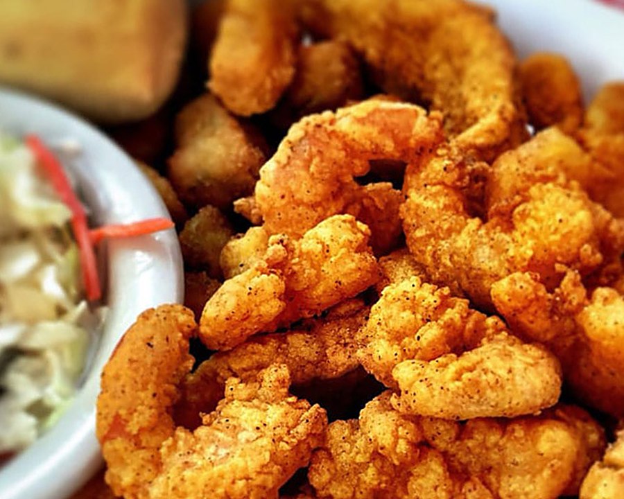 A basket of fried shrimp with coleslaw